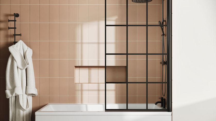 black framed shower screen in bathroom with peach coloured tiles