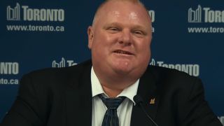 Rob Ford smiling at a press conference in Trainwreck: Mayor of Mayhem