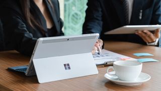 Microsoft Surface tablet on desk with businesman and businesswoman