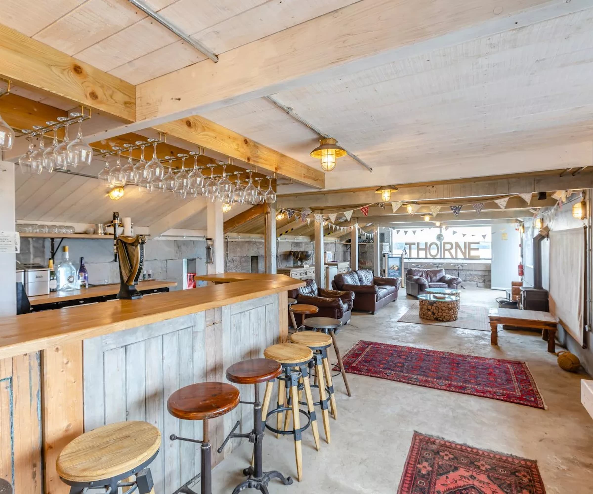 A home bar made from wood and a large seating area