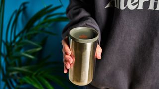 Wacaco Pipamoka portable coffee maker in front of a blue background.