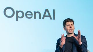 OpenAI CEO Sam Altman chats on stage with OpenAI in the background