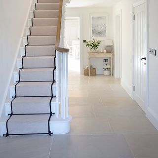 hallway with limestone tiled flooring and white walls
