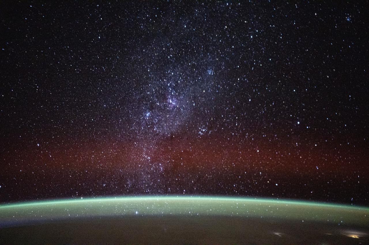 countless stars shine above the curve of earth, as seen from the international space station