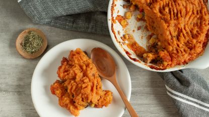 Mashed root vegetable dish is portioned into a bowl