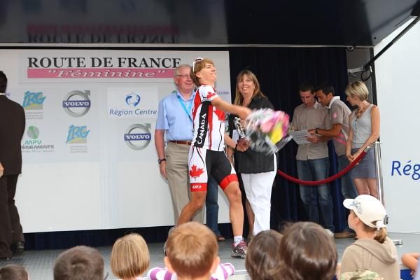 Anne Samplonius (Canada) launches her bouquet of flowers into the crowd after the podium ceremony.