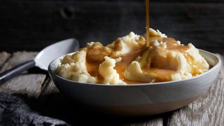 Gravy being poured over mash