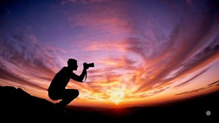 AI generated image showing silhouette of a photographer against a vivid sunset