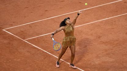 Naomi Osaka serves in her loss to Aryna Sabalenka