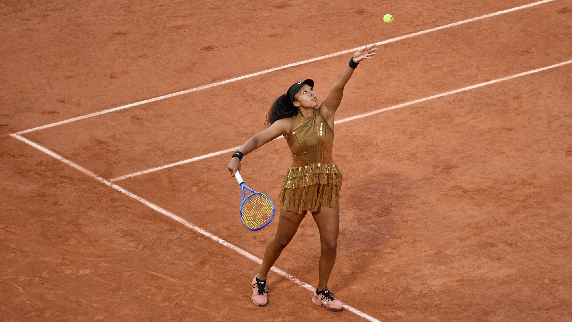 Naomi Osaka serves in her loss to Aryna Sabalenka