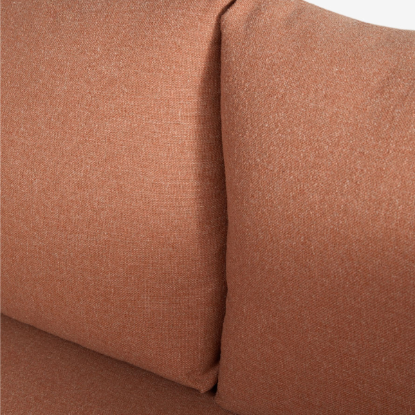A close up of the corner of Next's Abel Rattan Garden Modular Sofa in Rust Brown