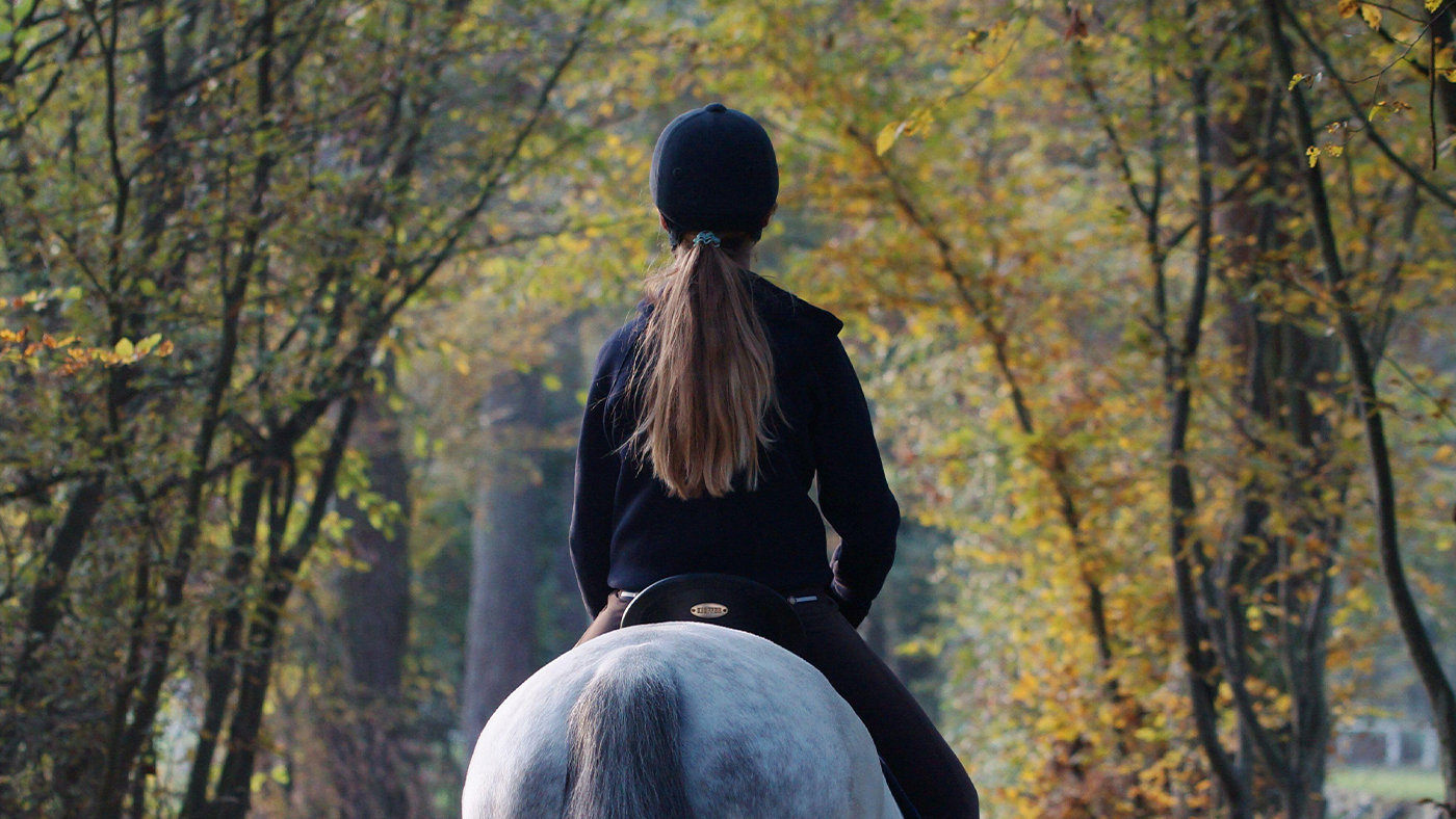 Lady riding in inexpensive riding hat