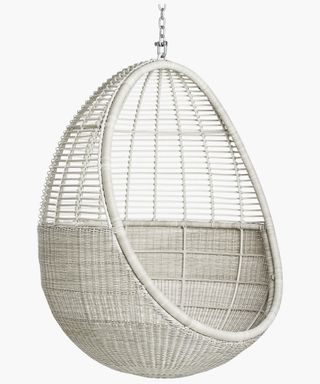 An off-white egg chair with galvanized metal chain and faux wicker frame