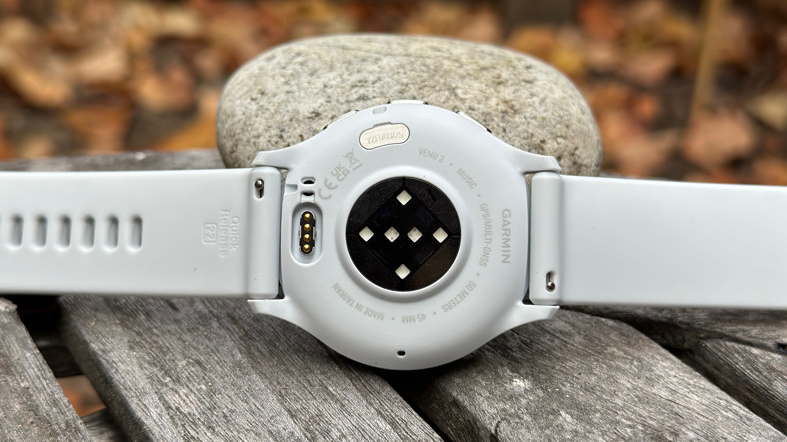 A bottom view of the Garmin Venu 3, showing the new Elevate v5 heart rate sensor and the Quick Release watch bands with their sliding pins.