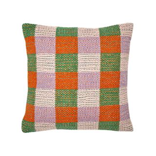 An orange and green check outdoor cushion