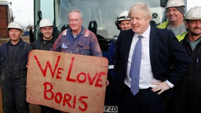 Boris Johnson poses with workers during a visit to Wilton Engineering Services