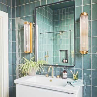 bathroom with blue tiles and black framed mirror above modern white vanity unit