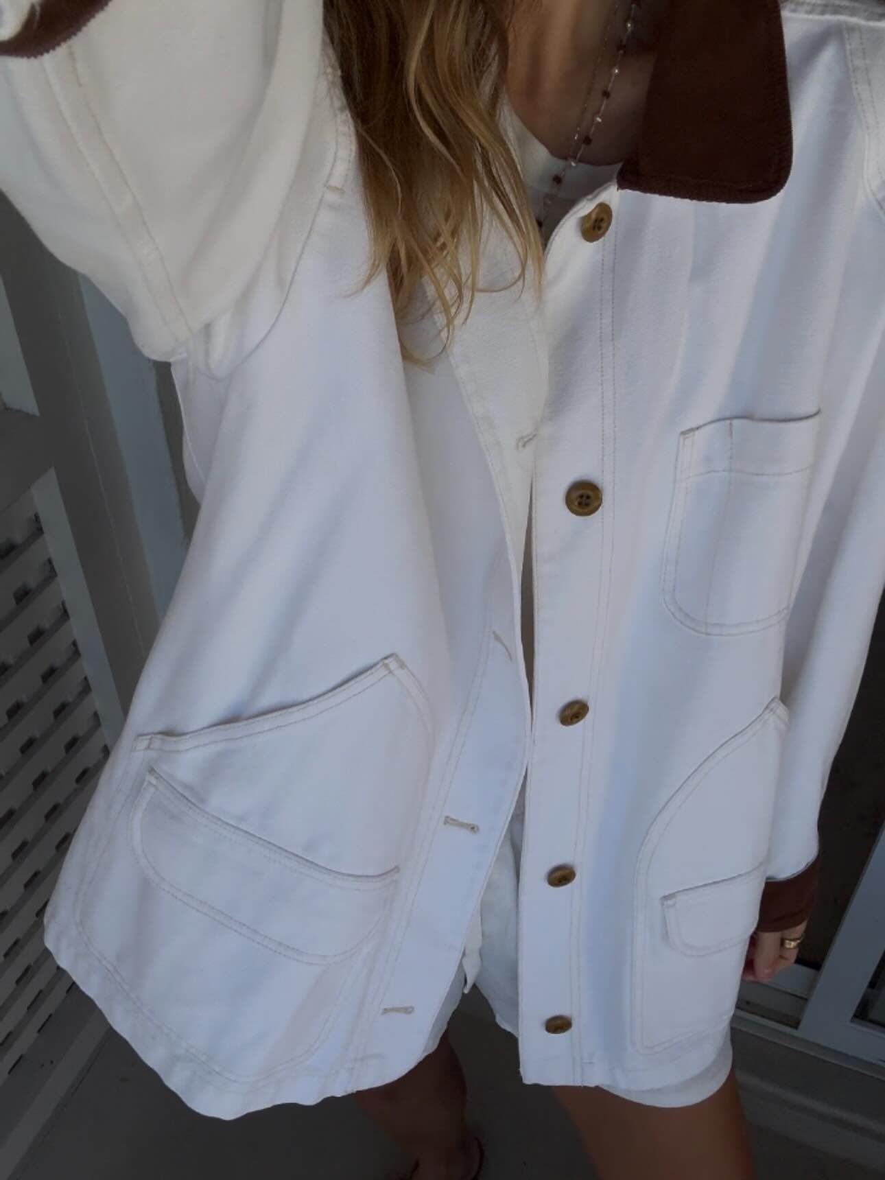 Angie wears a jacket by Doen.
