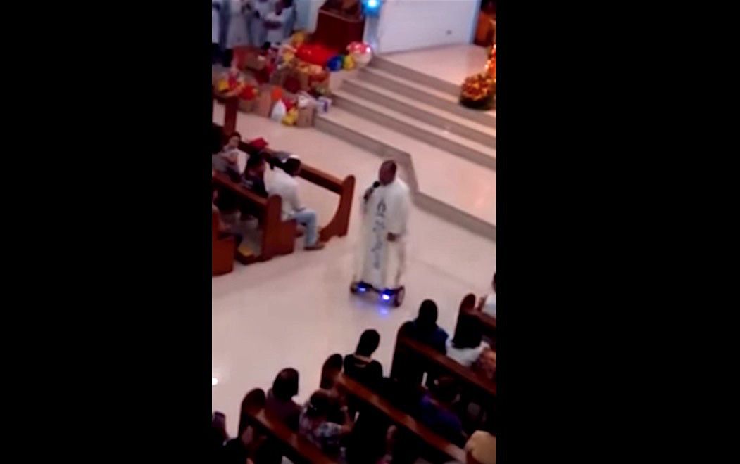 A Catholic priest in the Philippines rides a hoverboard at Mass