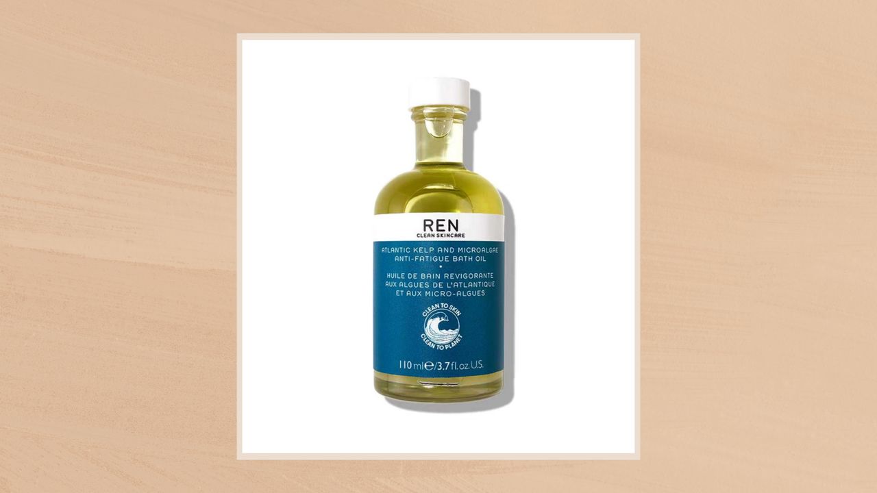 Image of the REN Atlantic Kelp and Microalgae Bath Oil in a taupe frame set against a warm beige background