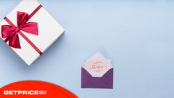 Blue background with a present wrapped in white paper with a red bow on it and a card that says Happy Mothers Day with the Get Price logo on bottom left corner