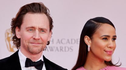 British actor Tom Hiddleston (L) and British actress Zawe Ashton pose on the red carpet upon arrival at the BAFTA British Academy Film Awards at the Royal Albert Hall, in London, on March 13, 2022.