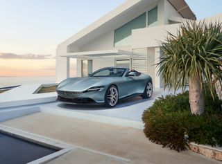 Ferrari Roma Spider in front of house by ocean