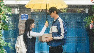 Kim Hye-yoon as Im Sol and Byeon Woo-seok as Ryu Sun-jae standing under an umbrella in 'Lovely Runner'