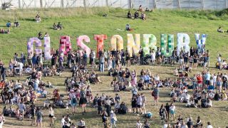 Crowds gather at the Glastonbury festival sign on Day 2 of the 2025 event