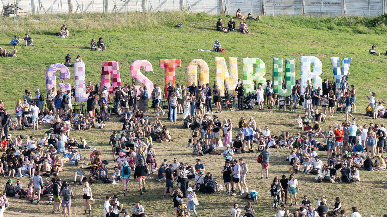Crowds gather at the Glastonbury festival sign on Day 2 of the 2025 event