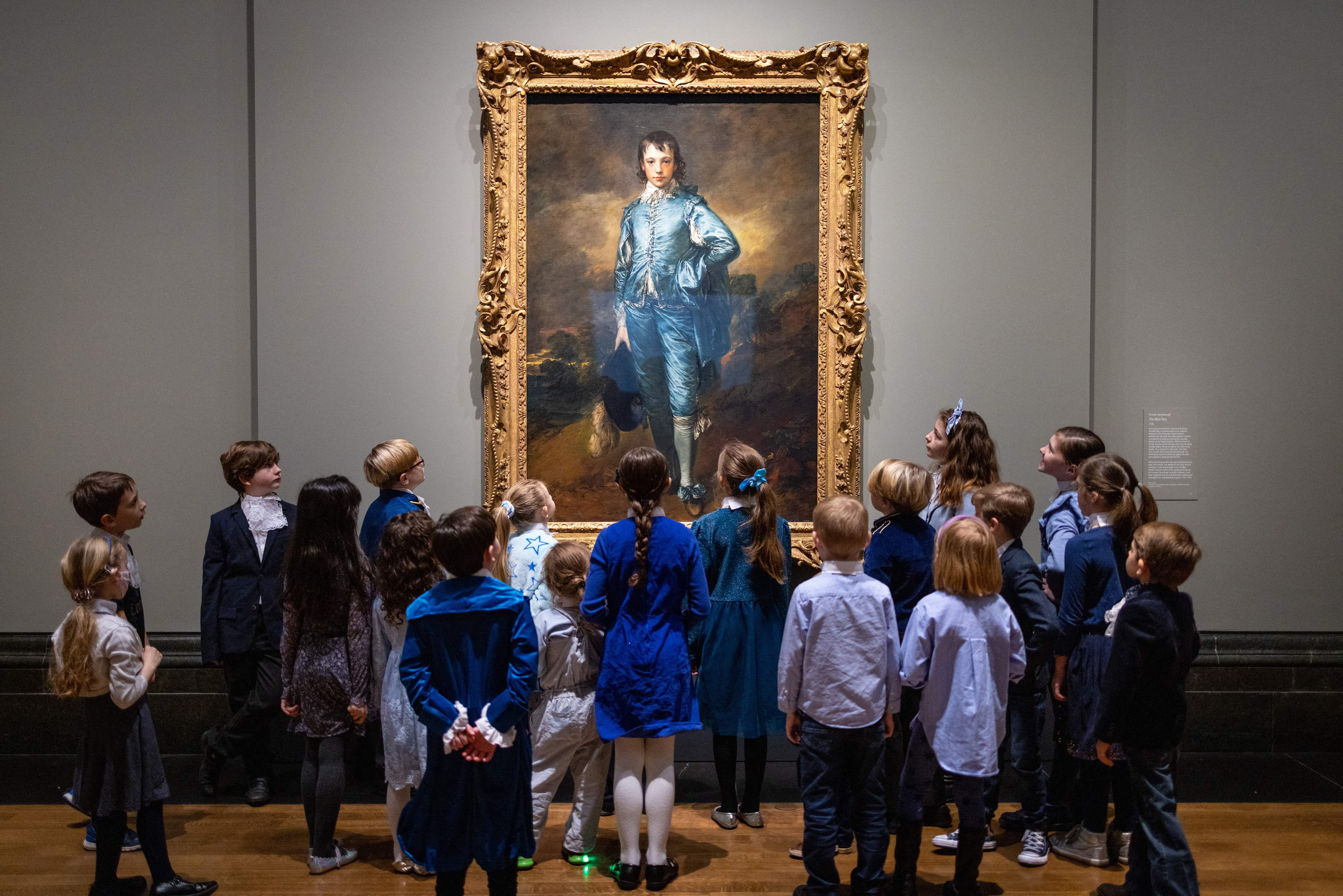 A group of schoolchildren looking at The Blue Boy by Gainsborough