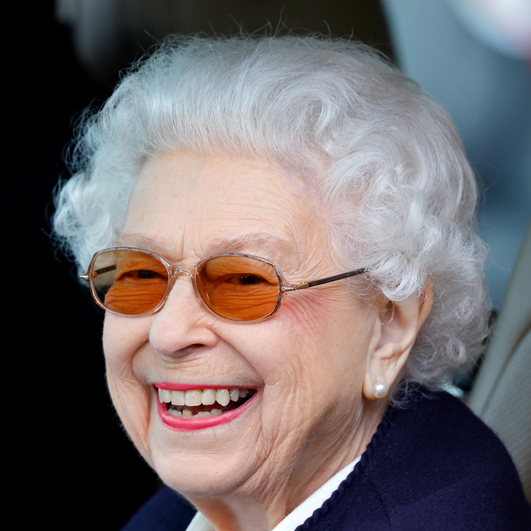 Queen Elizabeth wearing sunglasses and smiling