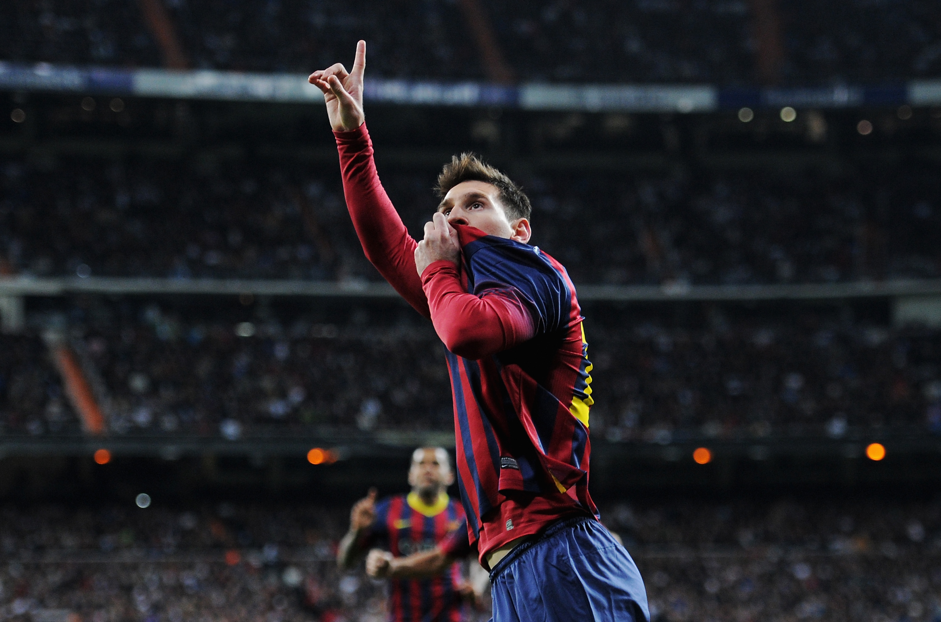 Lionel Messi celebrates after scoring Barcelona's fourth goal against Real Madrid at the Santiago Bernabeu in April 2014.