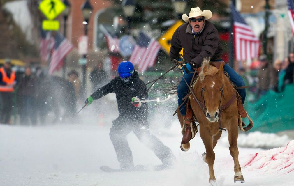 Jorge Calzadillas races down Harrison Avenue while towing a skier during the annual Ski Joring competition in Colorado