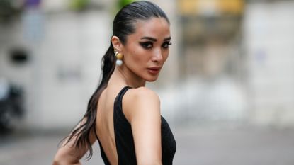 Heart Evangelista wears a sleeveless black long mesh bodysuit with fluffy pants and floral embroidery, outside Roberto Cavalli, during the Milan Fashion Week - Womenswear Spring/Summer 2024 on September 20, 2023 in Milan, Italy. 