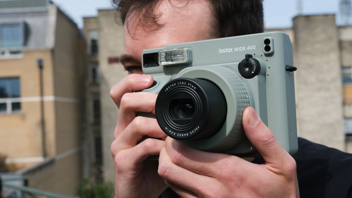 Fujifilm Instax Wide 400 camera held up a person&#039;s face