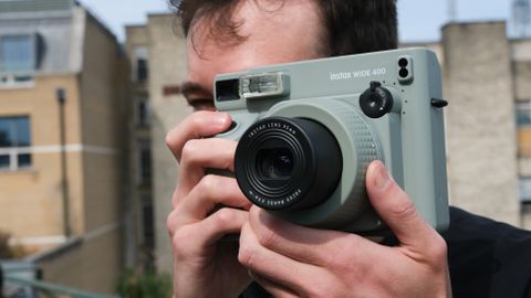 Fujifilm Instax Wide 400 camera held up a person&#039;s face