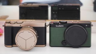 Panasonic Lumix L10 next to a Lumix S9, in front of a mirror