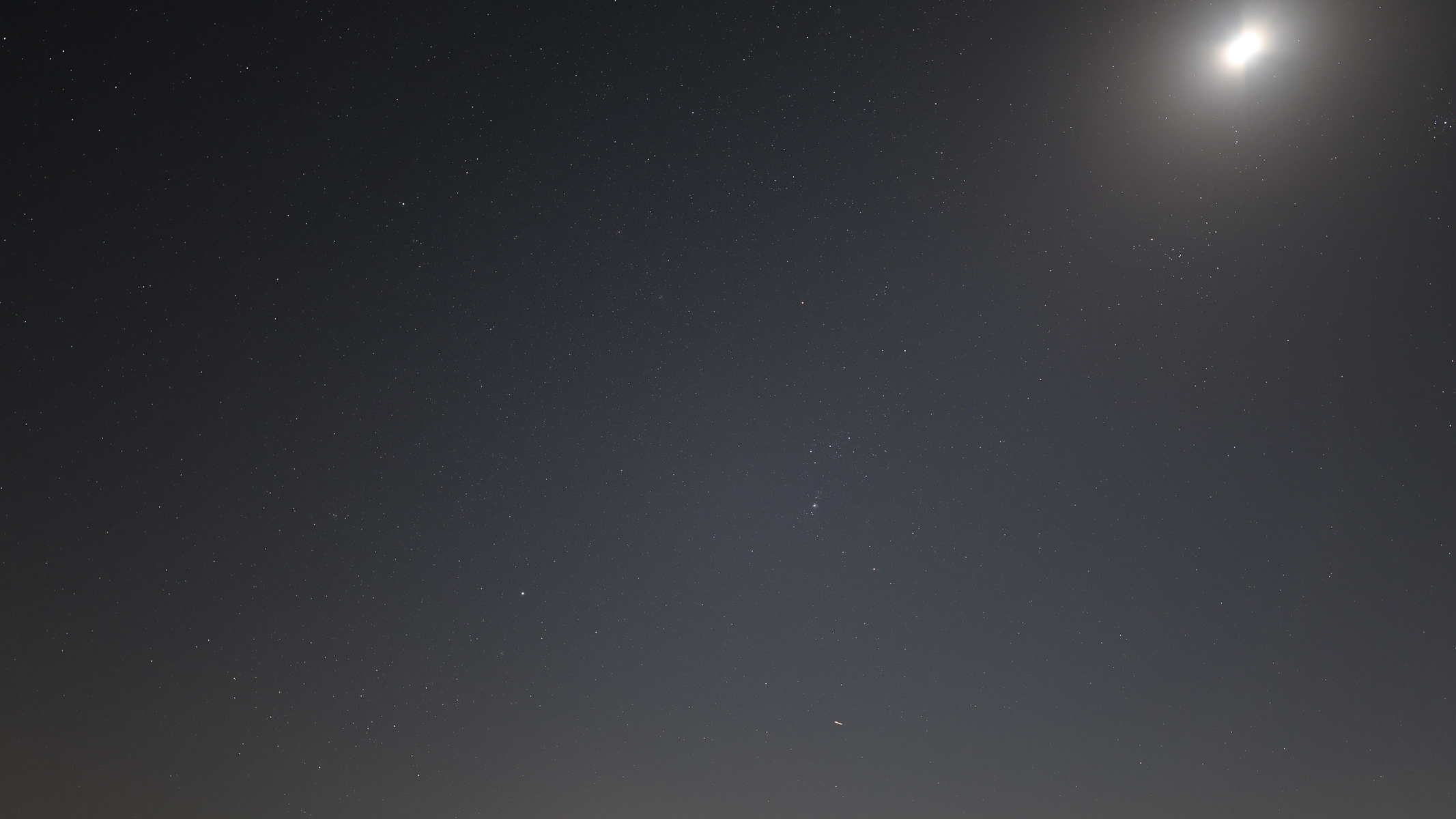 Orion and the moon in the starry night sky photographed with the Canon EOS R5 II and Canon RF 20mm f/1.4 L VCM lens.