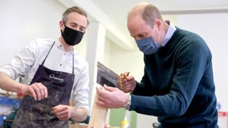 rince William, Duke of Cambridge (R) in the centre's workshop, which makes furniture from recycled pews and other responsibly-resourced wood, during his visit to the Grassmarket Community Project