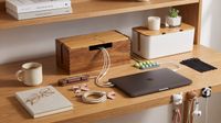 cable organisers on a desk with a laptop and notebook