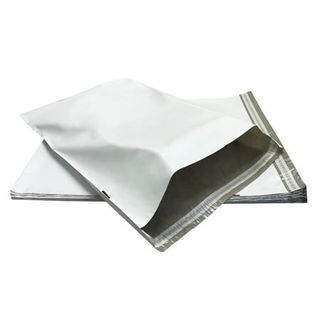 A pile of white mailing bags stacked on top of one another