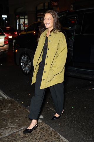 Katie Holmes styles an oversized jacket in an olive green shade.