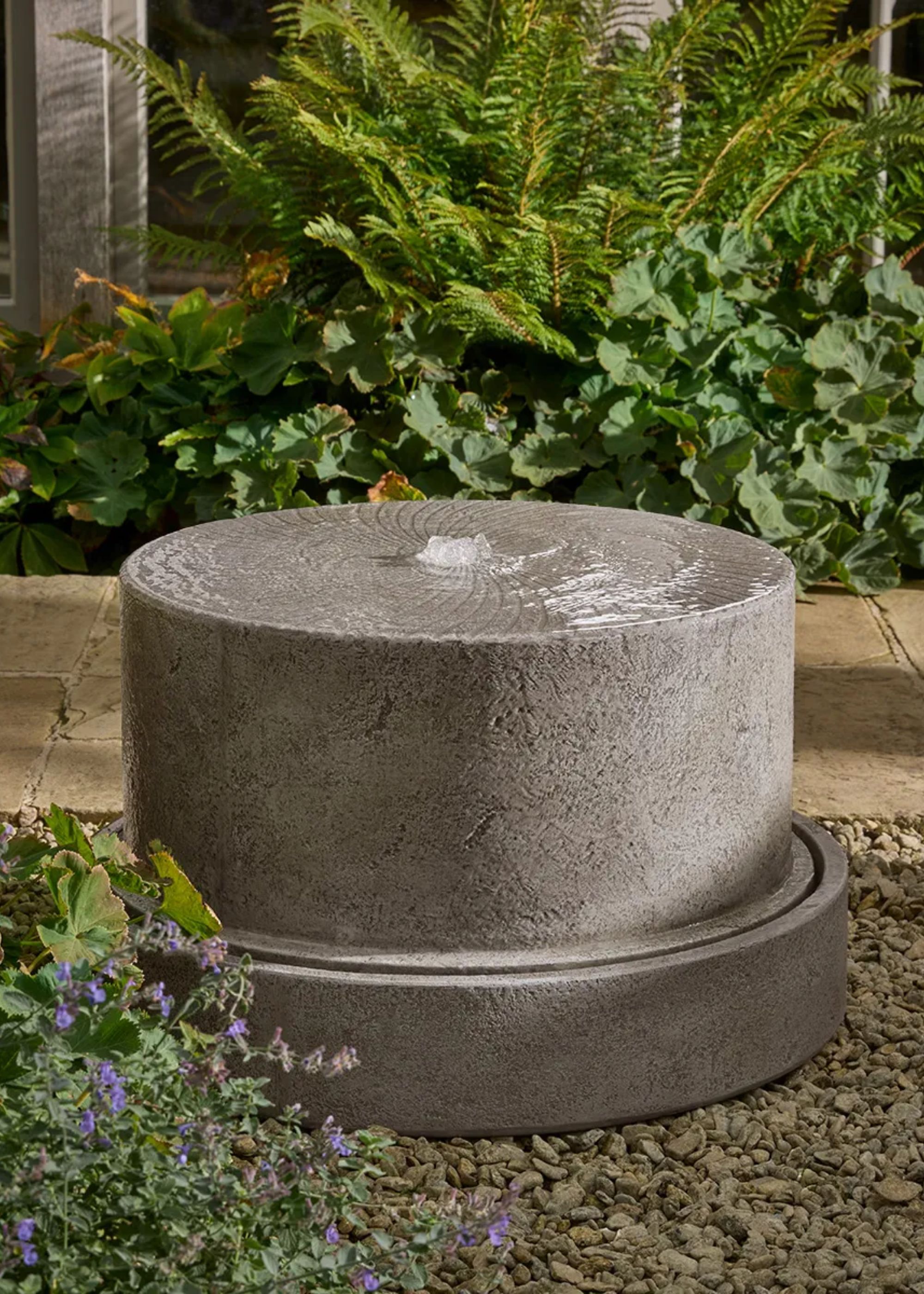 A concrete water feature from Cox &amp;amp; Cox styled in a gravel garden