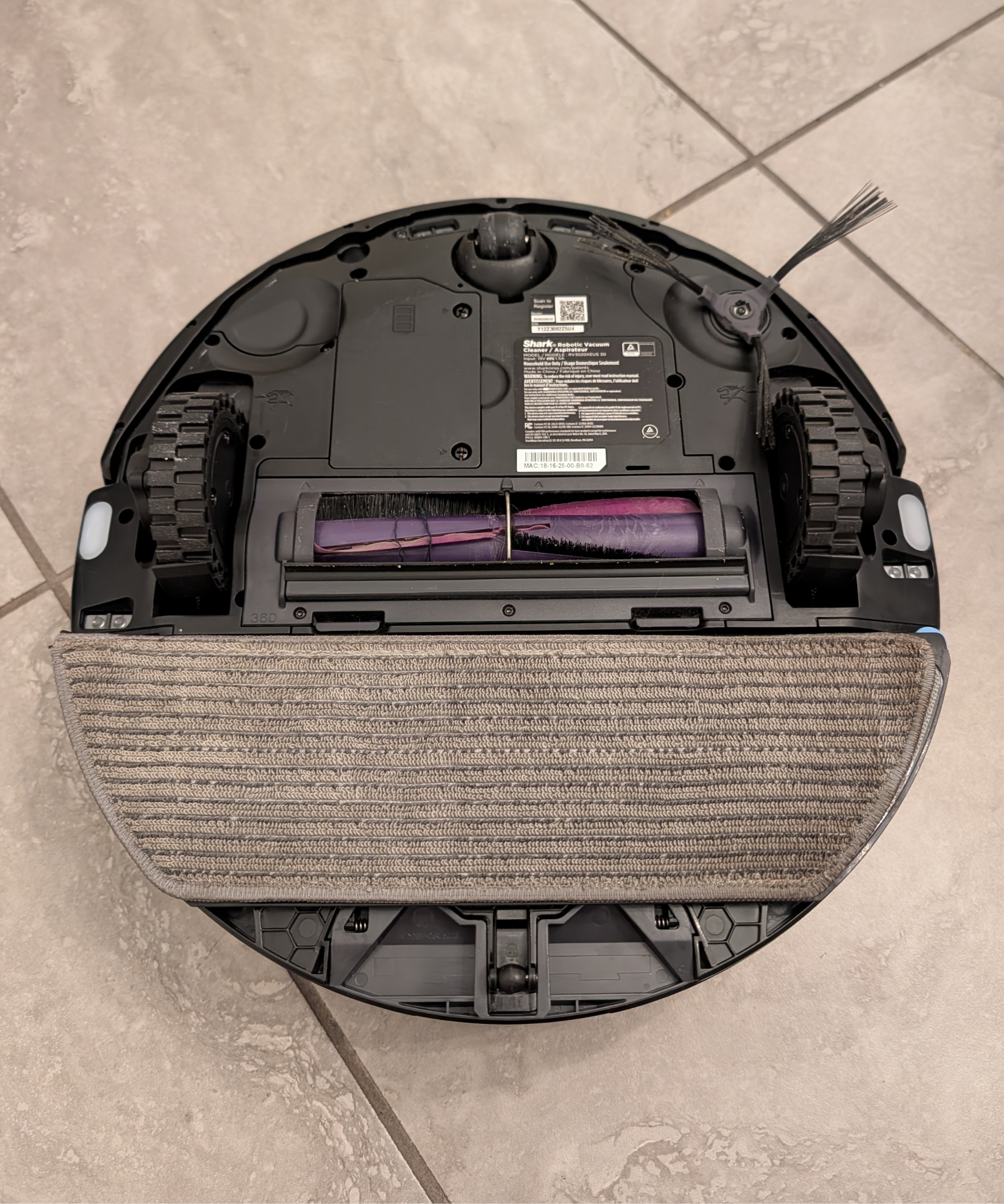 Bottom of the Shark PowerDetect UV Reveal showing the mopping bad, brushes, and wheels.