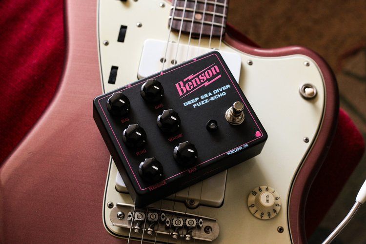 A Benson Amps Deep Sea Diver Fuzz-Echo pedal sits atop a burgundy mist metallica Jazzmaster