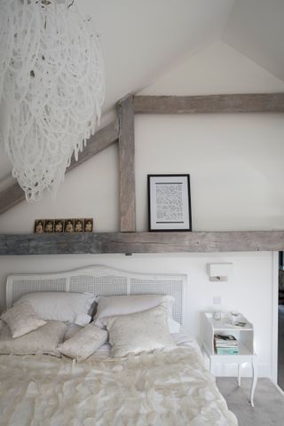 Rustic white bedroom with exposed beams