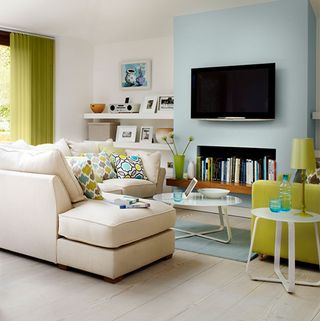 Living room with blue wall and cream sofa