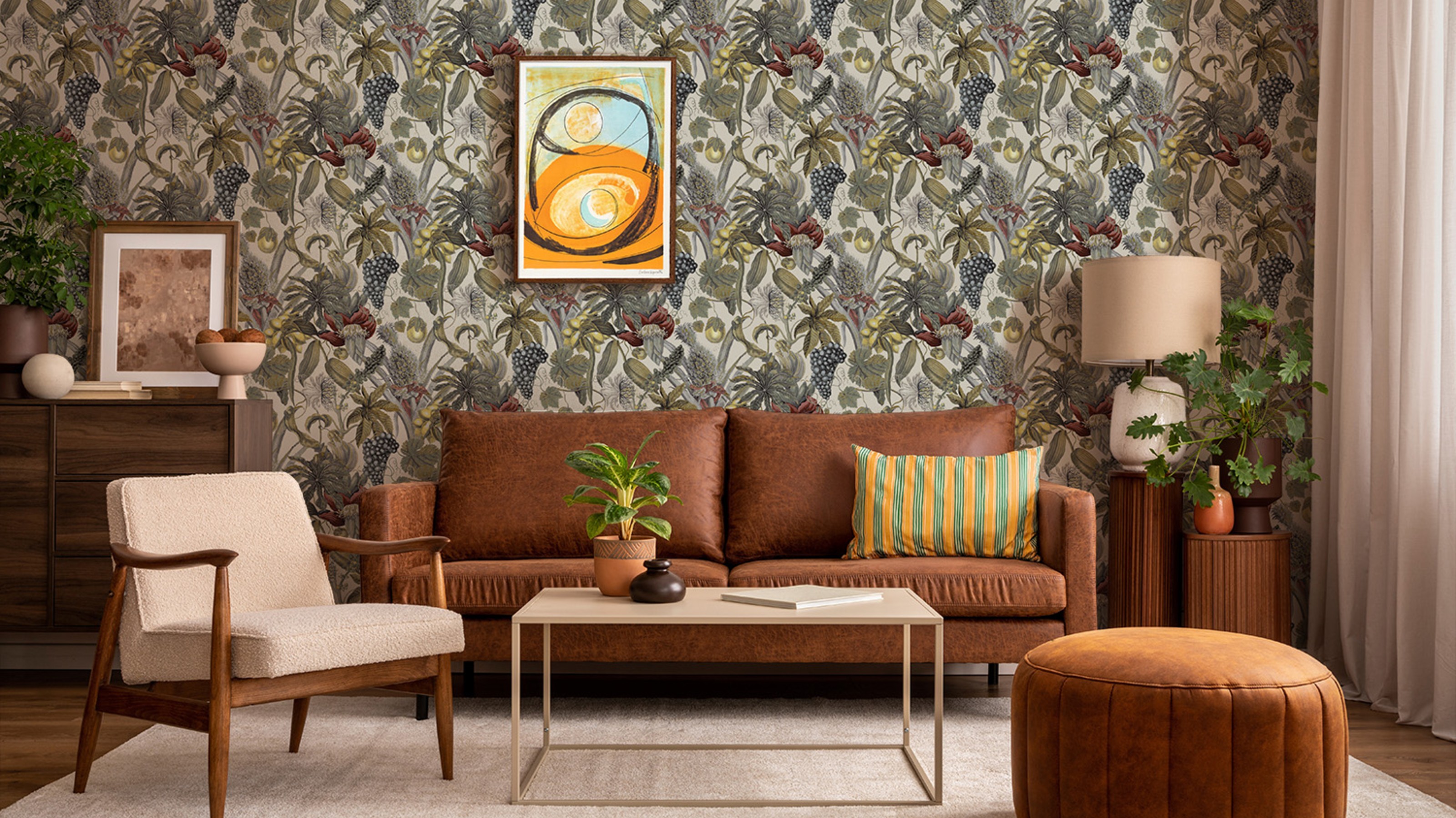 A living room with a bold tropical floral wallpaper from Wallpaper Direct and a brown leather sofa