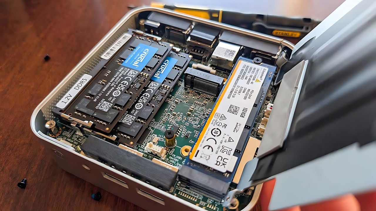 Inside Geekom A6 with RAM and SSD slots showing.